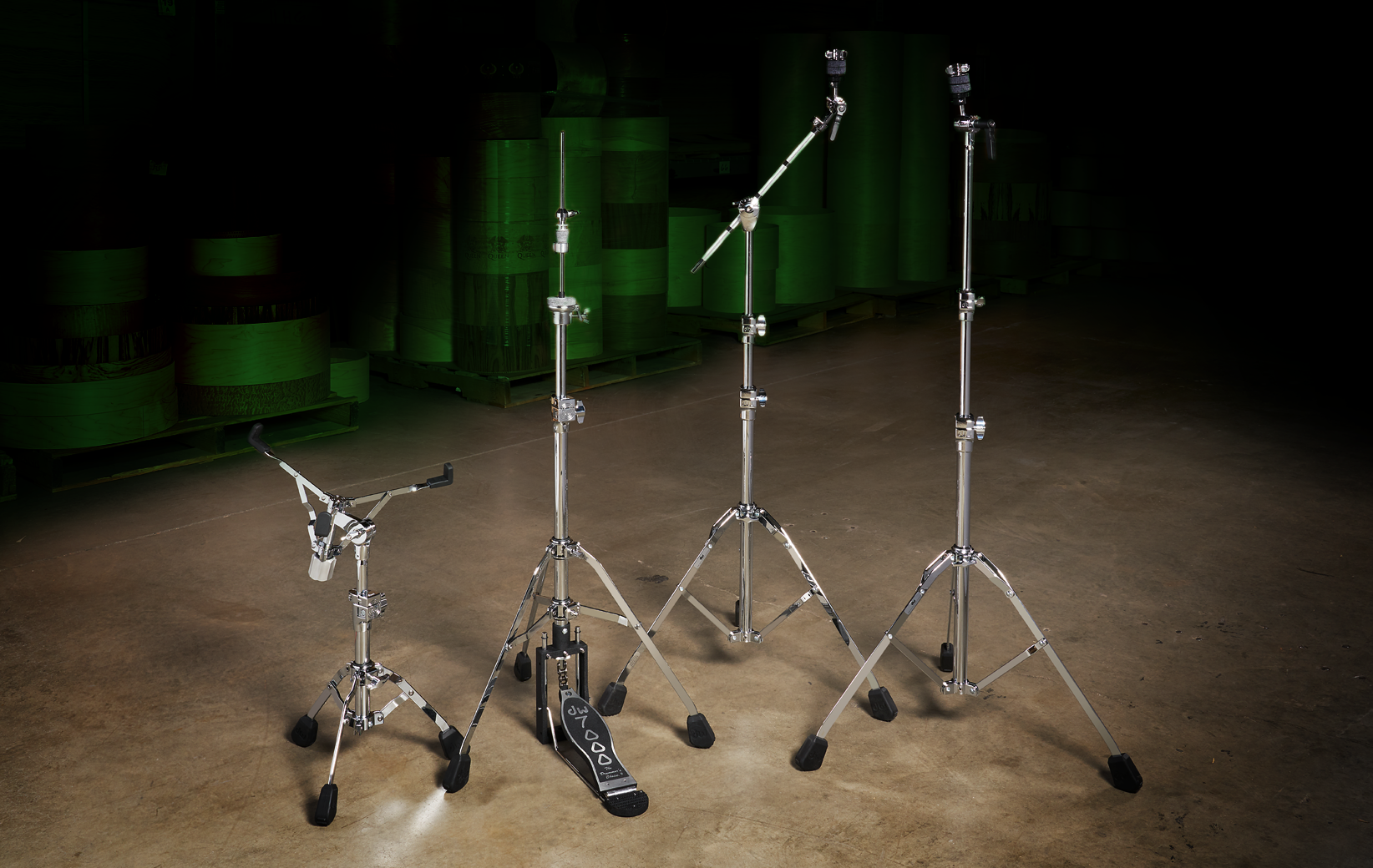 A lineup of the single-braced DW 7000 Series hardware line including a telescoping snare stand, hi-hat stand, boom stand, and straight stand.