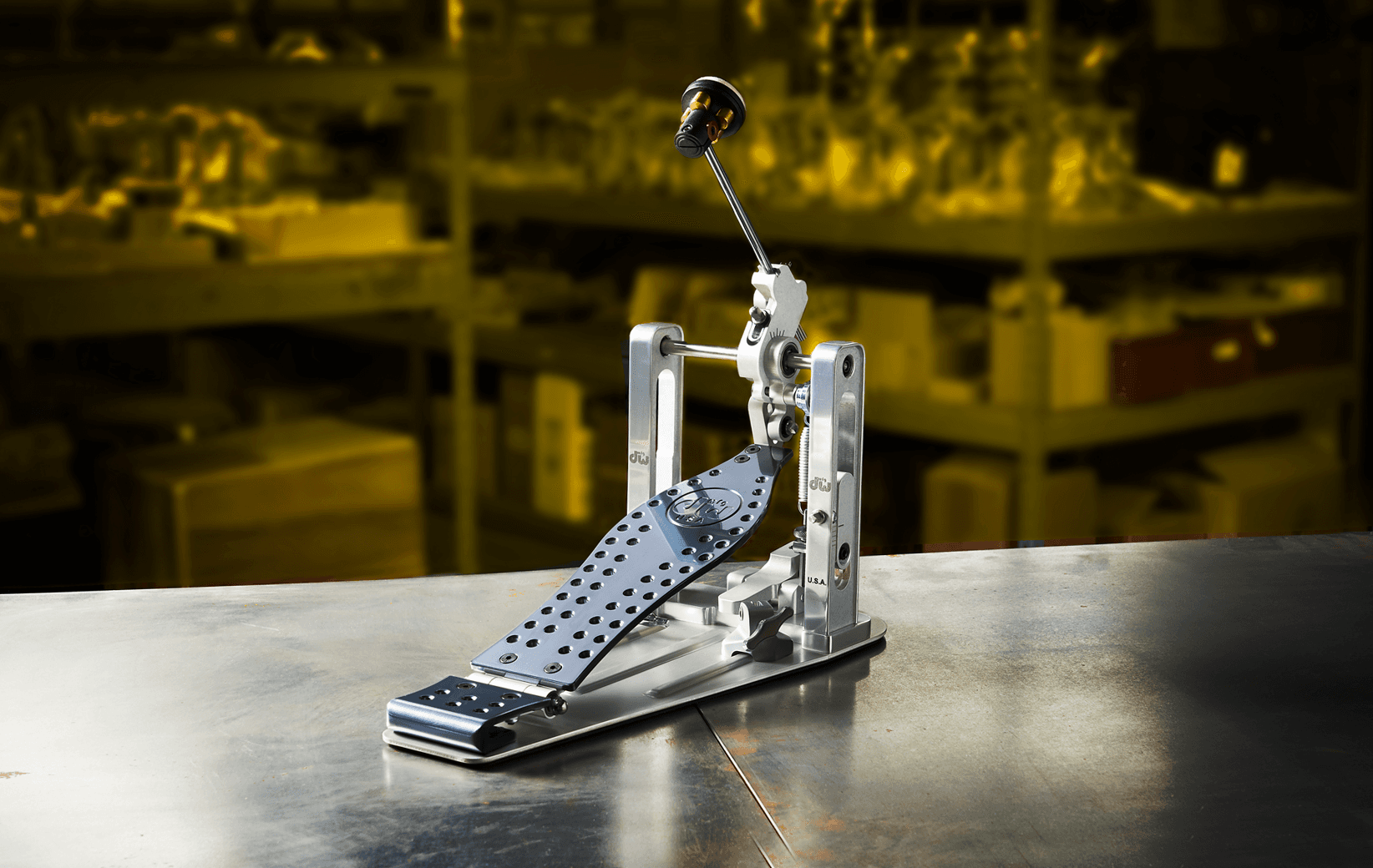 An American-made DW MFG Series pedal with a direct-drive cam and an anodized blue aluminum footboard.