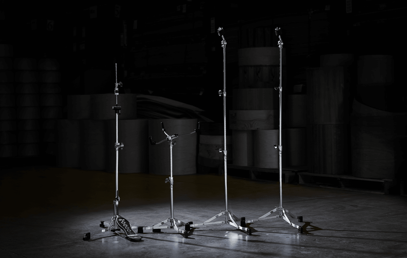 The low-profile, flat-base DW 6000 Series hardware line including a hi-hat stand, stare stand, and two straight-stand.